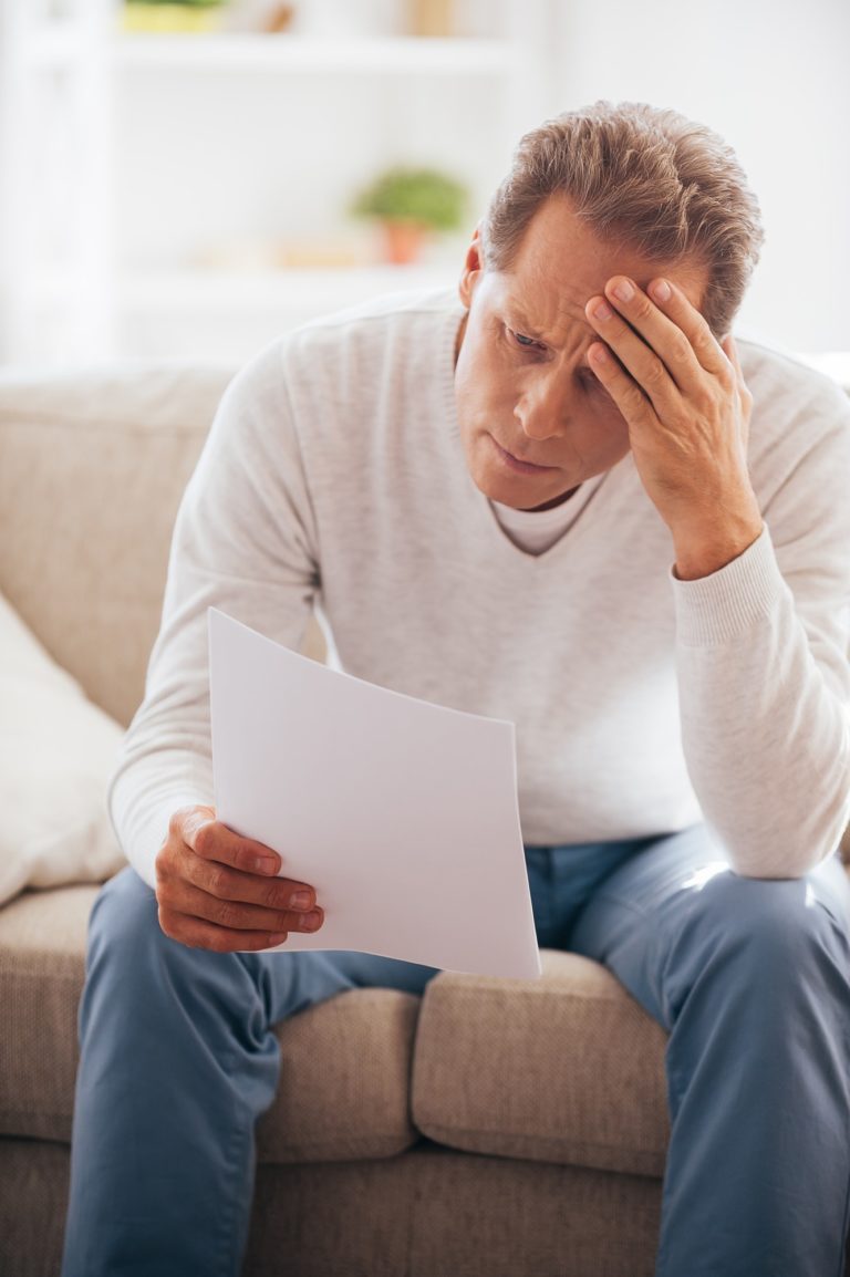 man stressed over high cost of prescriptions